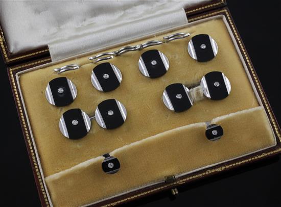 A 1930s/1940s 9ct white gold, diamond and black onyx eight piece dress stud set,